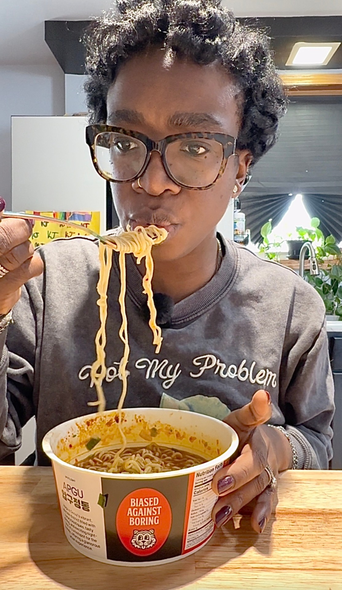 Ceva Brown eating BIAS Ramen noodles from a cup, showcasing authentic food-forward UGC content